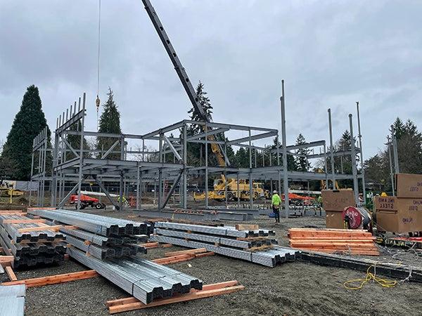 a crane lifts structural steel into place