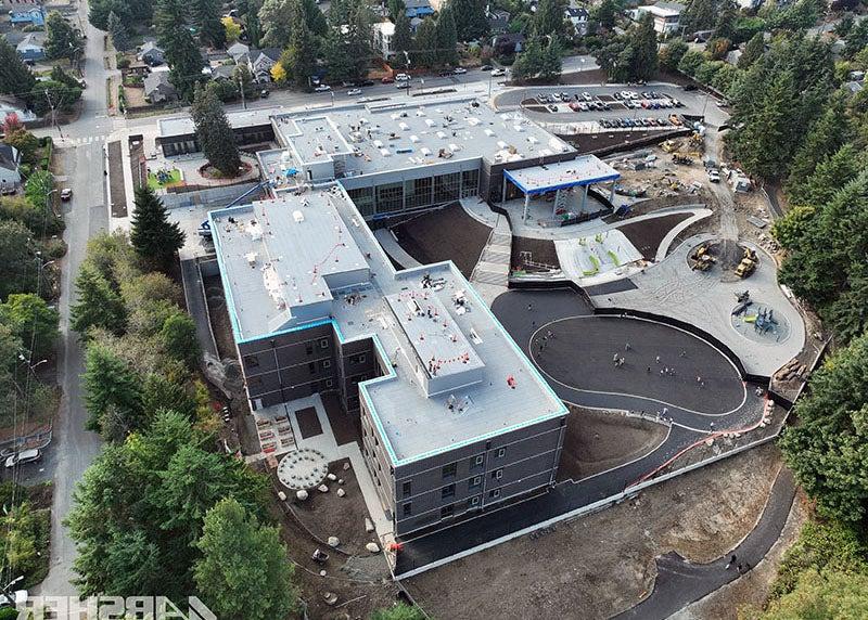 aerial photo of a large L shaped building on a sloped site